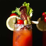 Bloody mary drink with lemon, celery, olives, cornichons and caper berries.