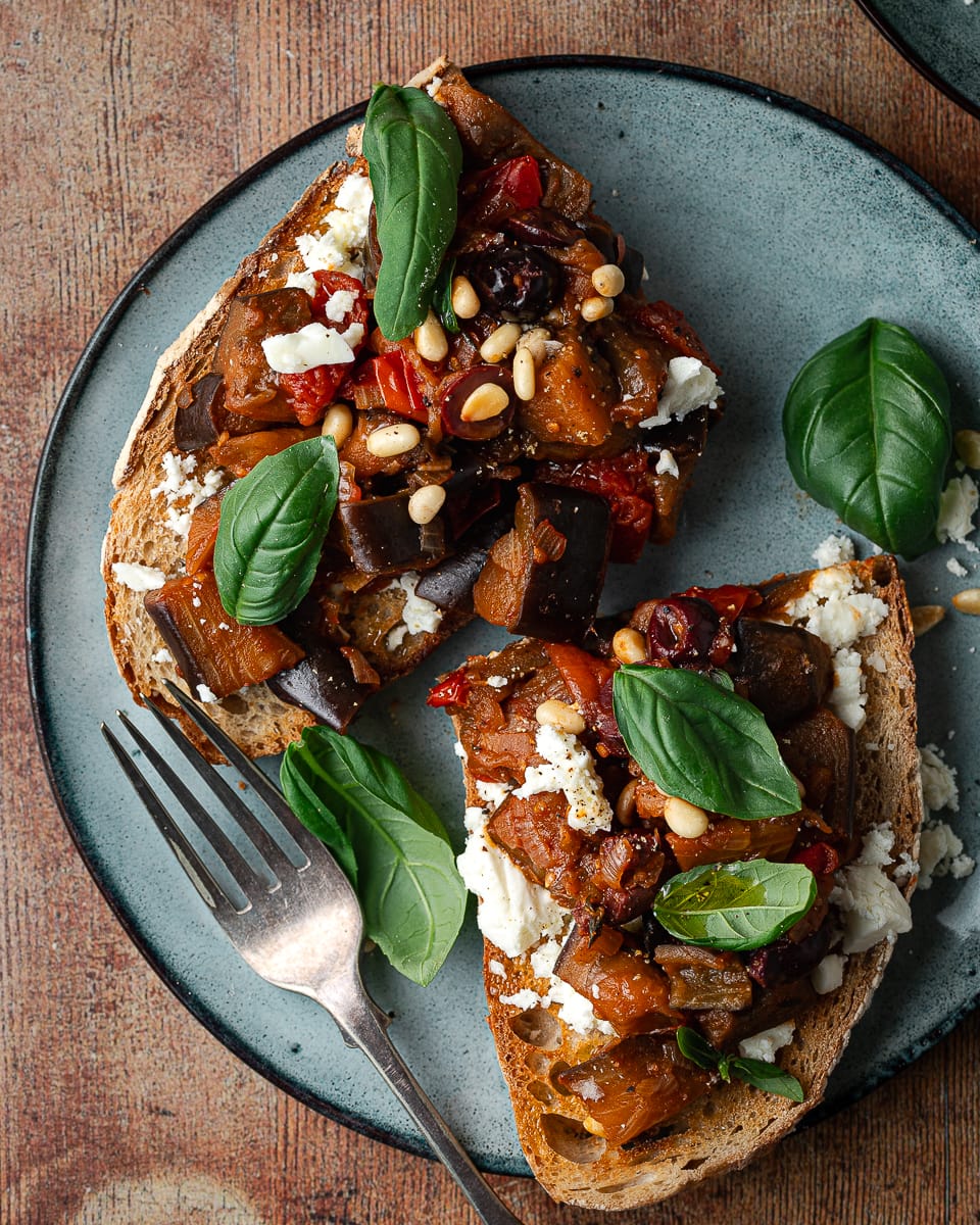 Tomato with aubergine on sourdough bread with basil and feta